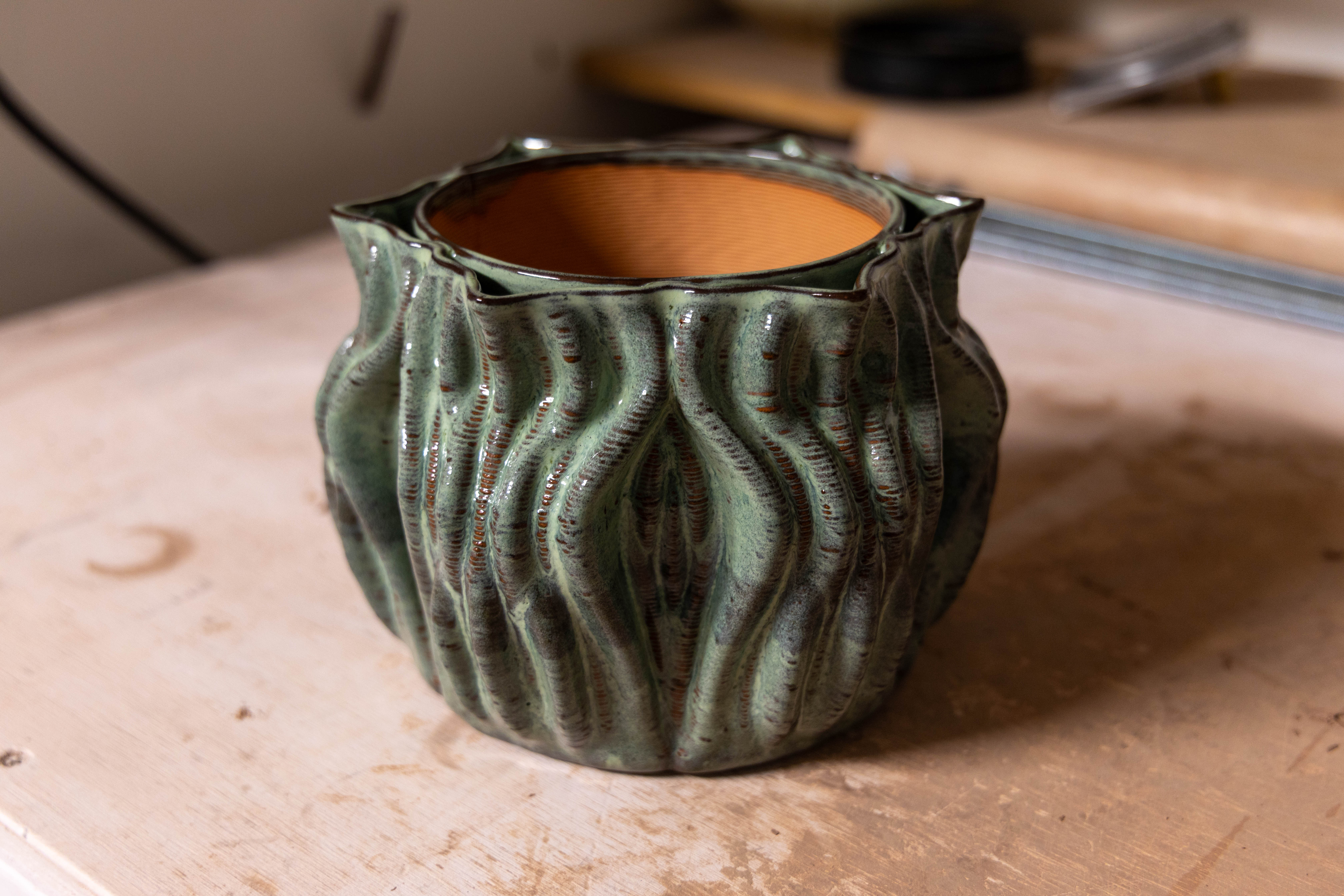 Iolla, a ribbed green-glazed planter with a terracotta inner pot